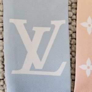Oversized LV initials on the blue section of the Nano bandeau