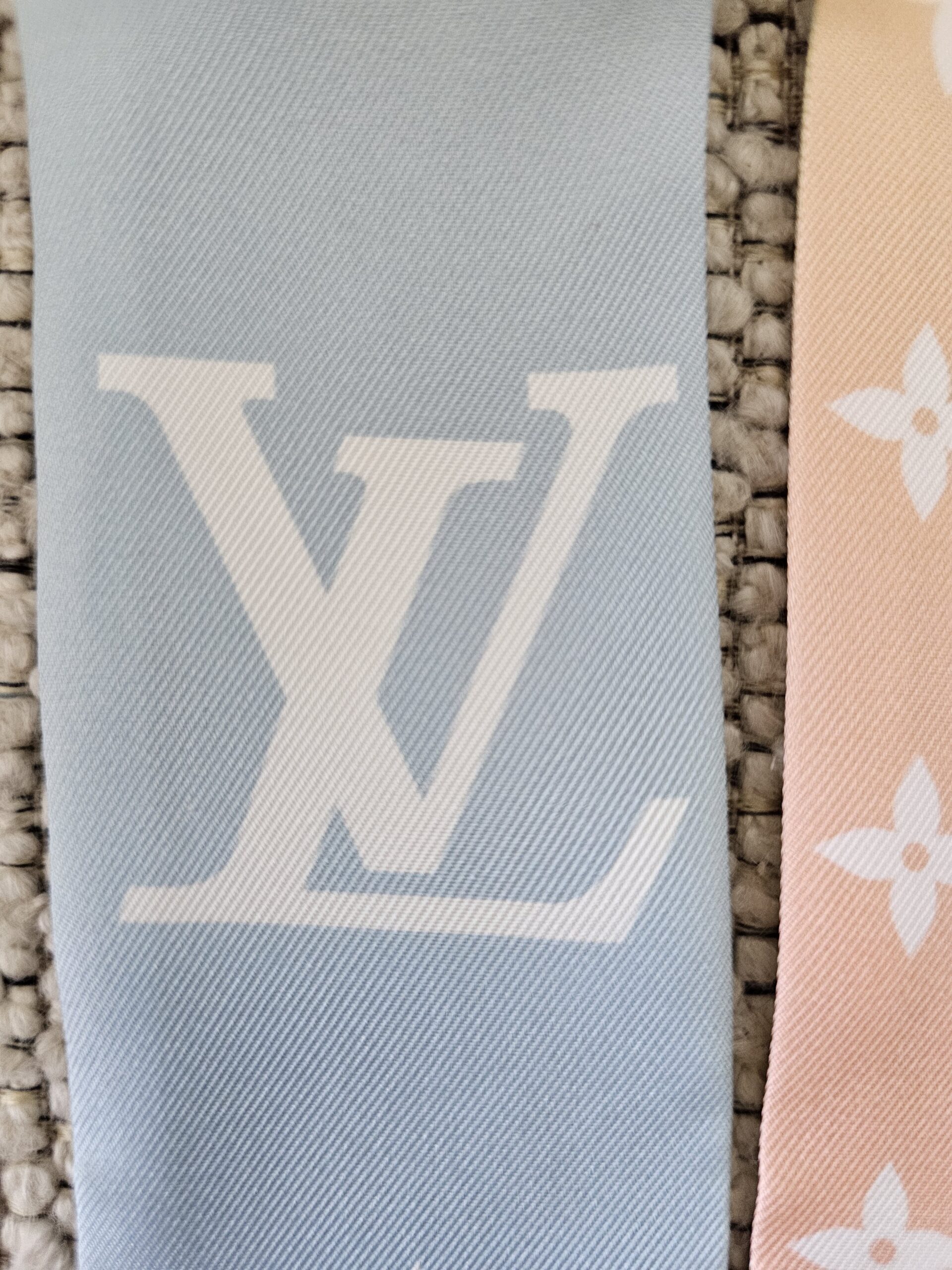 Oversized LV initials on the blue section of the Nano bandeau