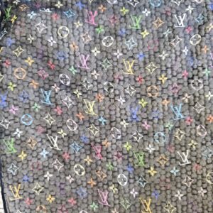 Close-up of the colorful Monogram initials and flowers on sheer black crepe silk
