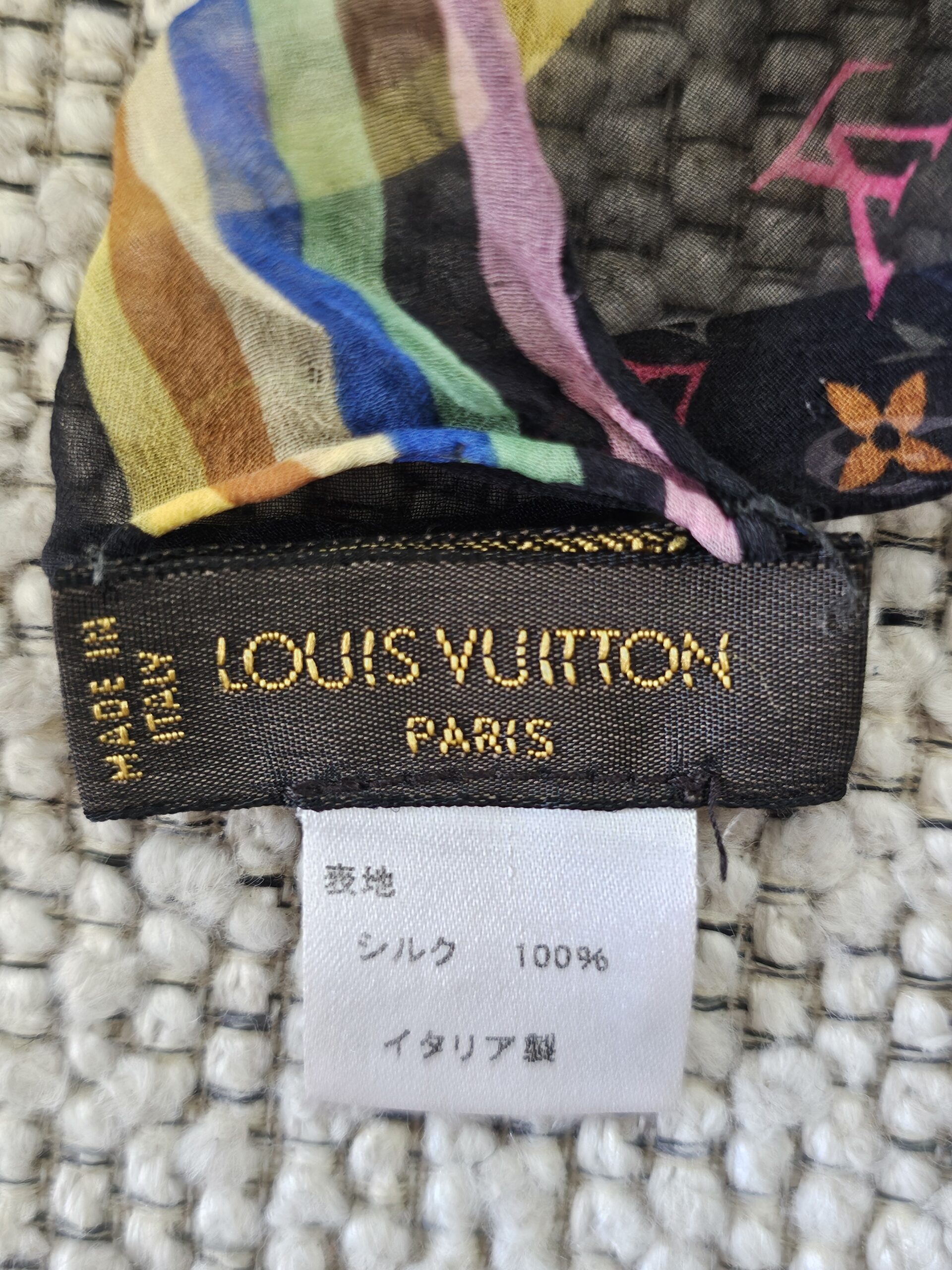 LOUIS VUITTON PARIS MADE IN ITALY label beside the multicolor striped border