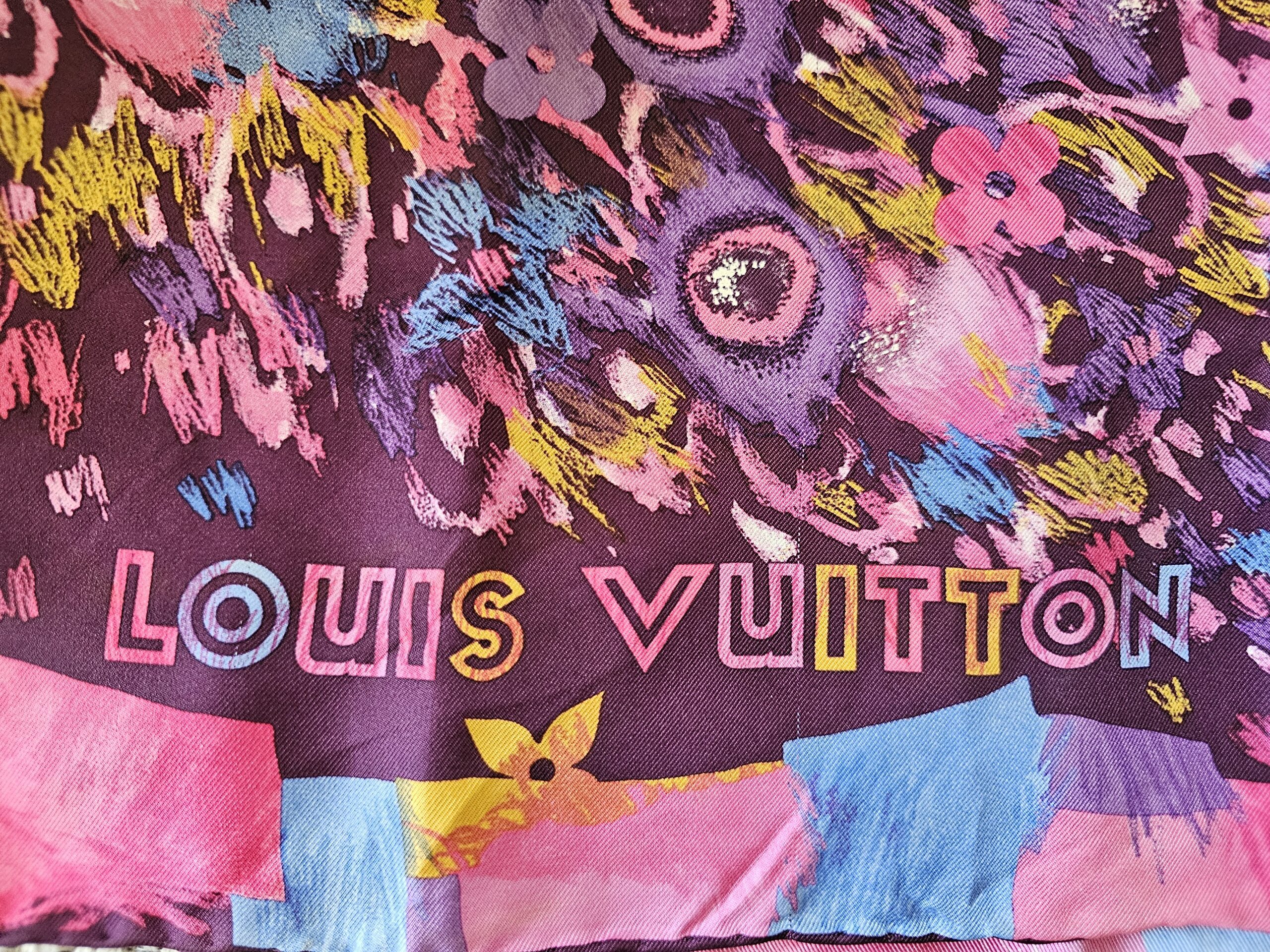 LOUIS VUITTON lettering in the painted border of the silk scarf