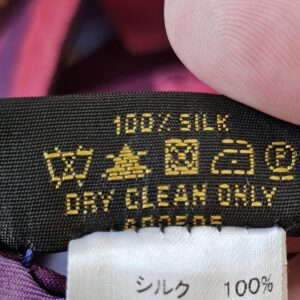 Close-up of the 100% SILK DRY CLEAN ONLY care label