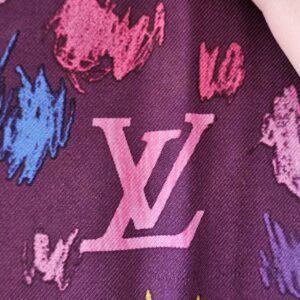 Pink painted LV initials on the purple silk
