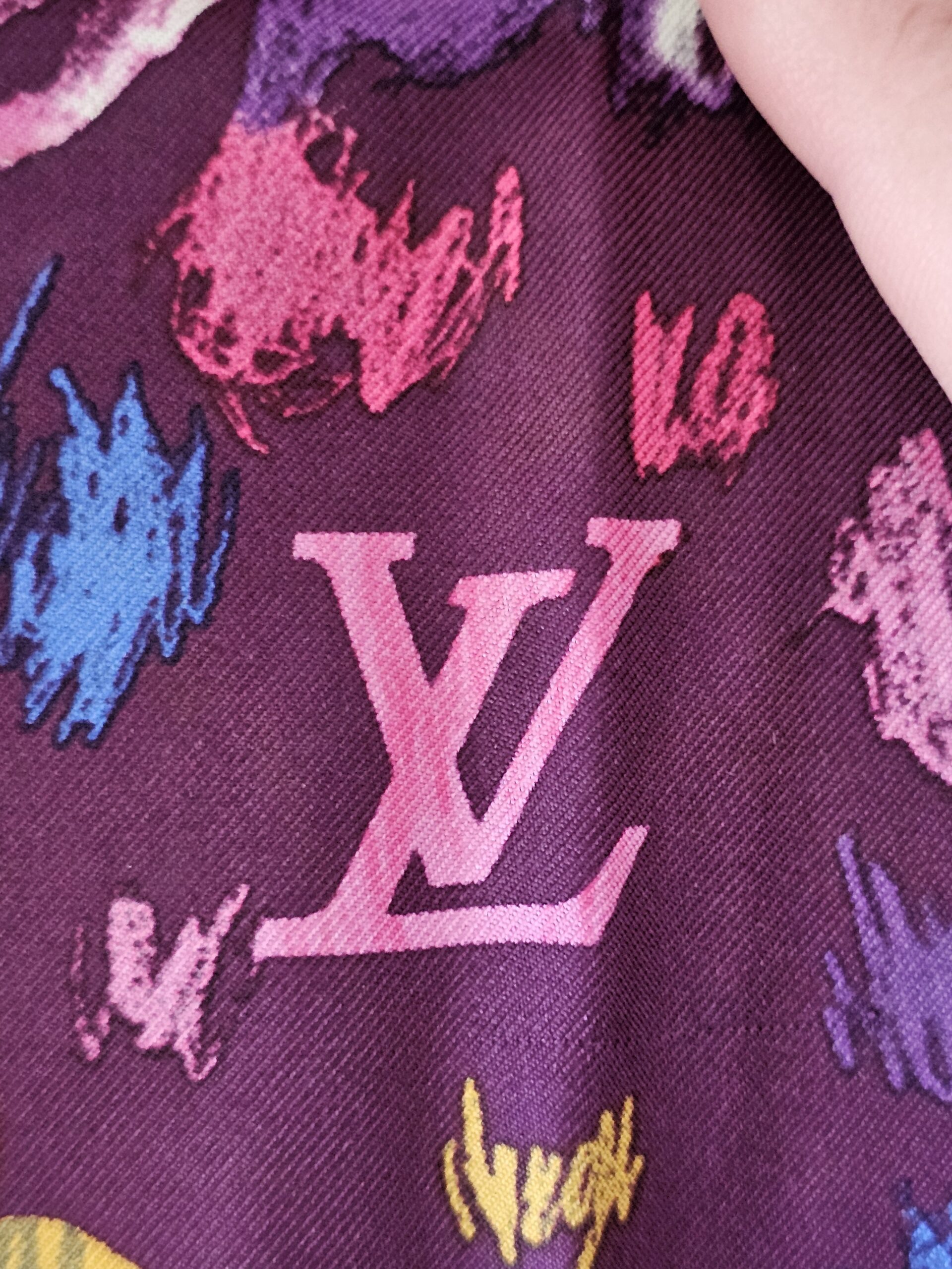 Pink painted LV initials on the purple silk