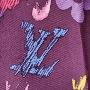Blue painted LV initials among the Monogram flowers on the silk scarf