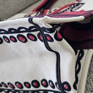 Corner of the Dioramour Book Tote showing rubbing along the embroidered edge