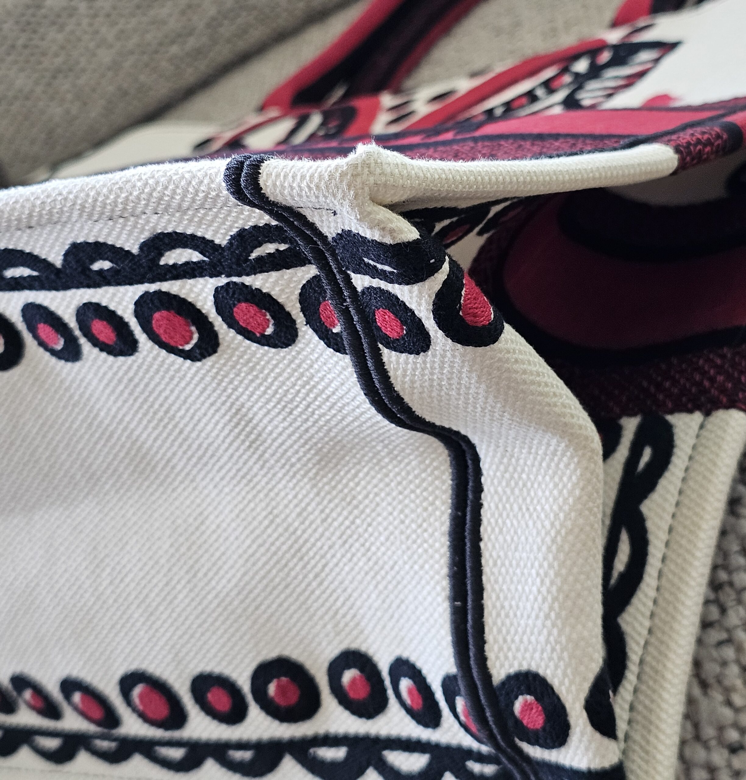 Corner of the Dioramour Book Tote showing rubbing along the embroidered edge