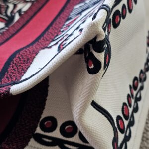 Corner edge of the Dioramour D-Chess Heart Book Tote showing rubbing