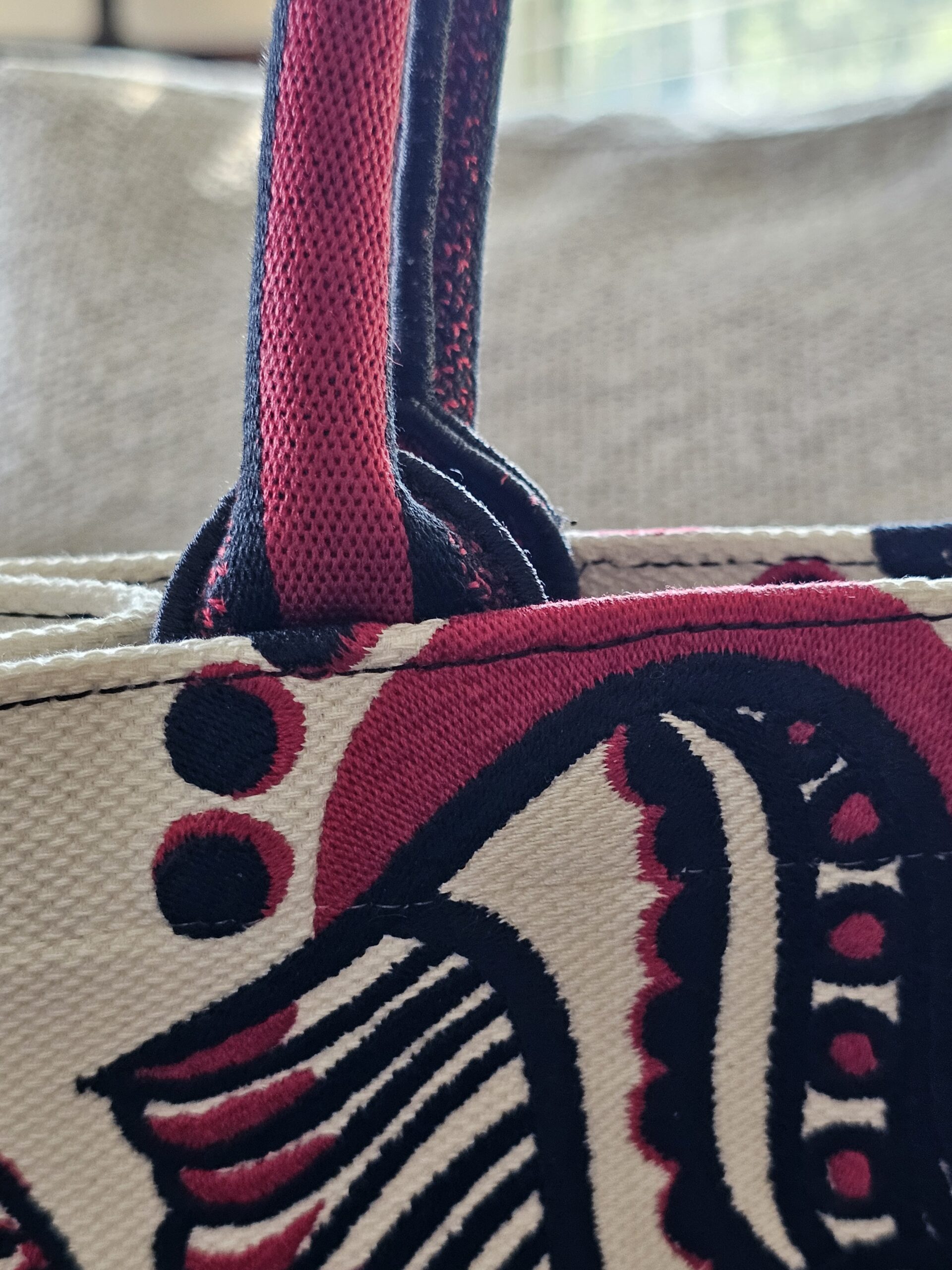 Base of an embroidered handle on the Dioramour Book Tote