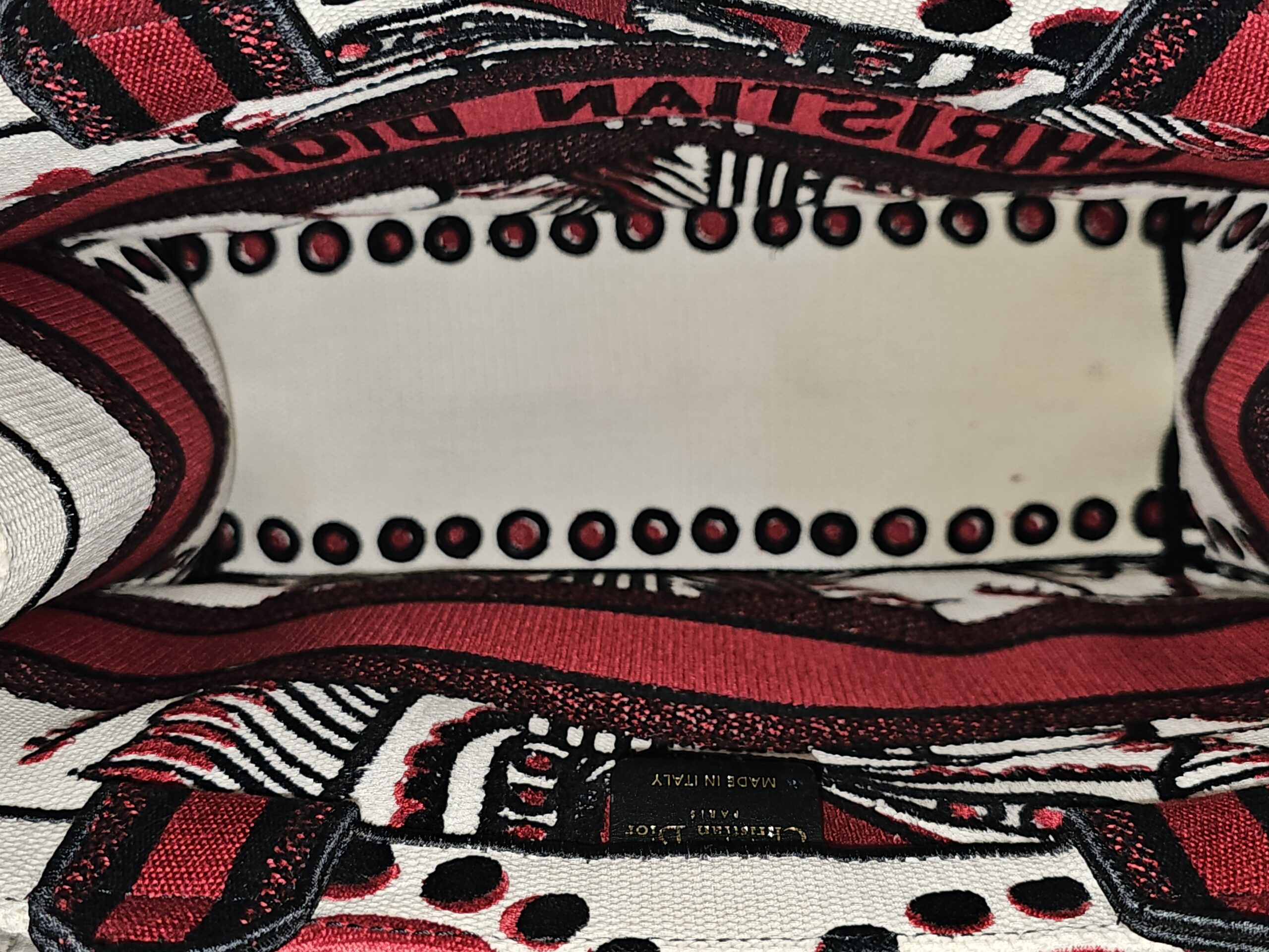 Embroidered interior of the Christian Dior Book Tote showing staining