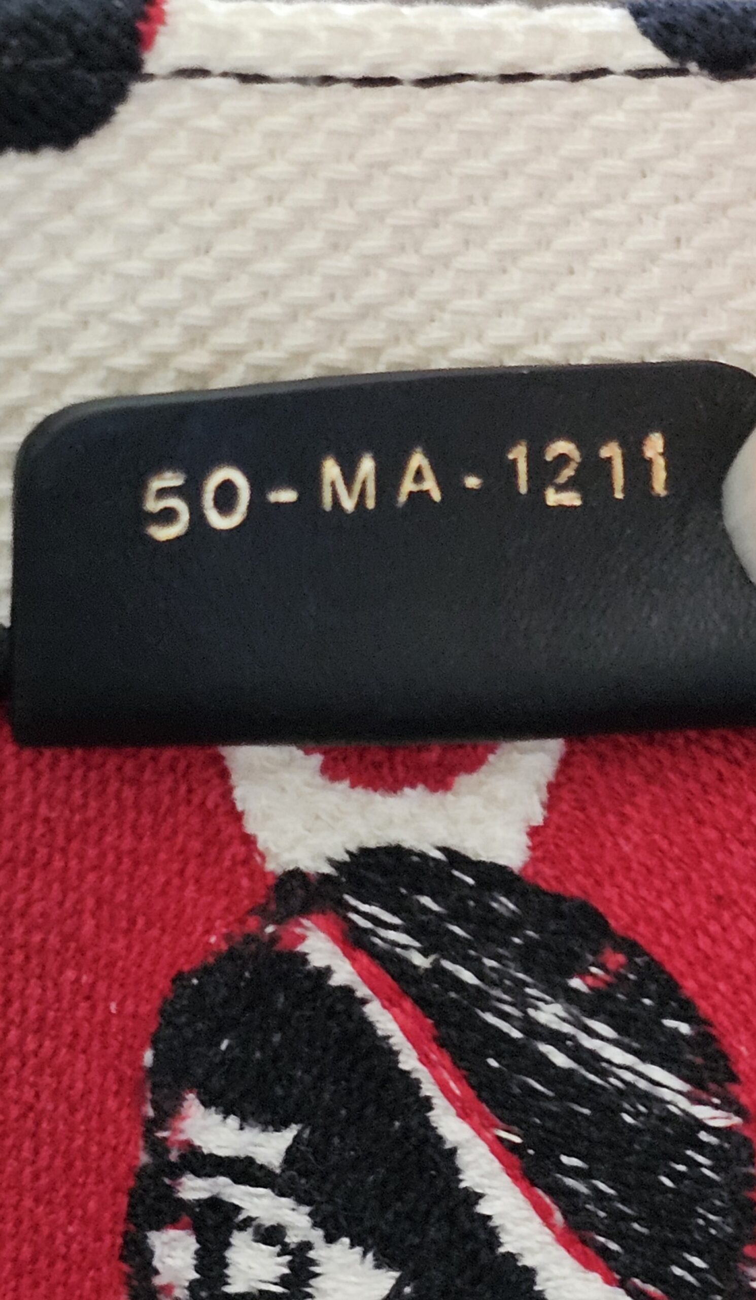 Production code 50-MA-1211 on the leather tab inside the Dioramour Book Tote