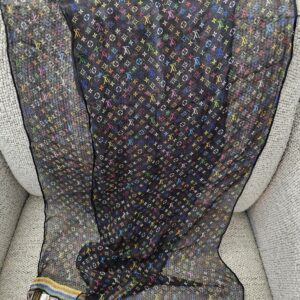 Sheer black Monogram Multicolor crepe scarf spread across a chair