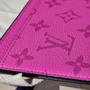Close-up of the embossed Monogram on fuchsia Taiga leather
