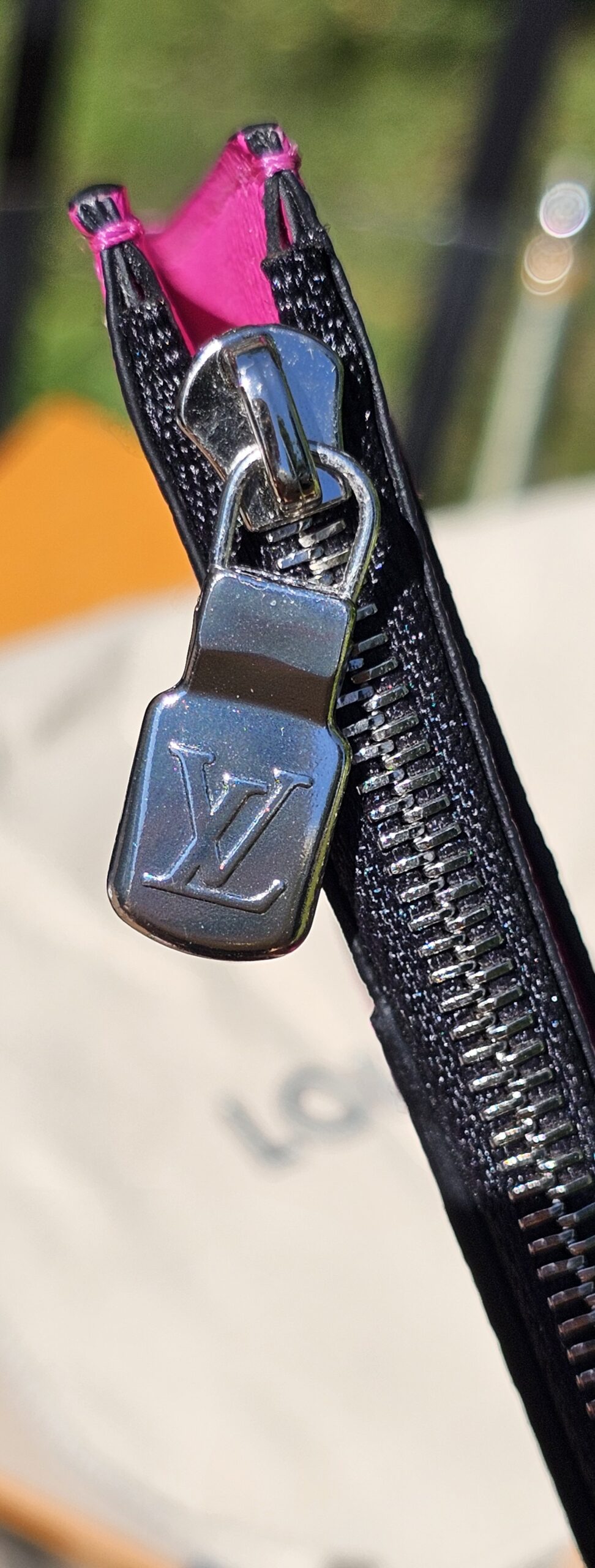 Silver-tone LV zip pull on the fuchsia coin card holder