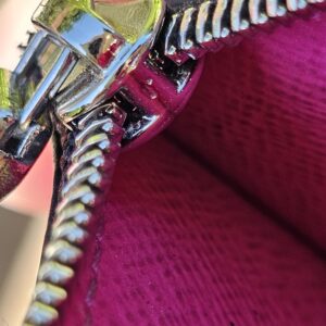 Silver-tone zipper detail on the fuchsia Taigarama card holder