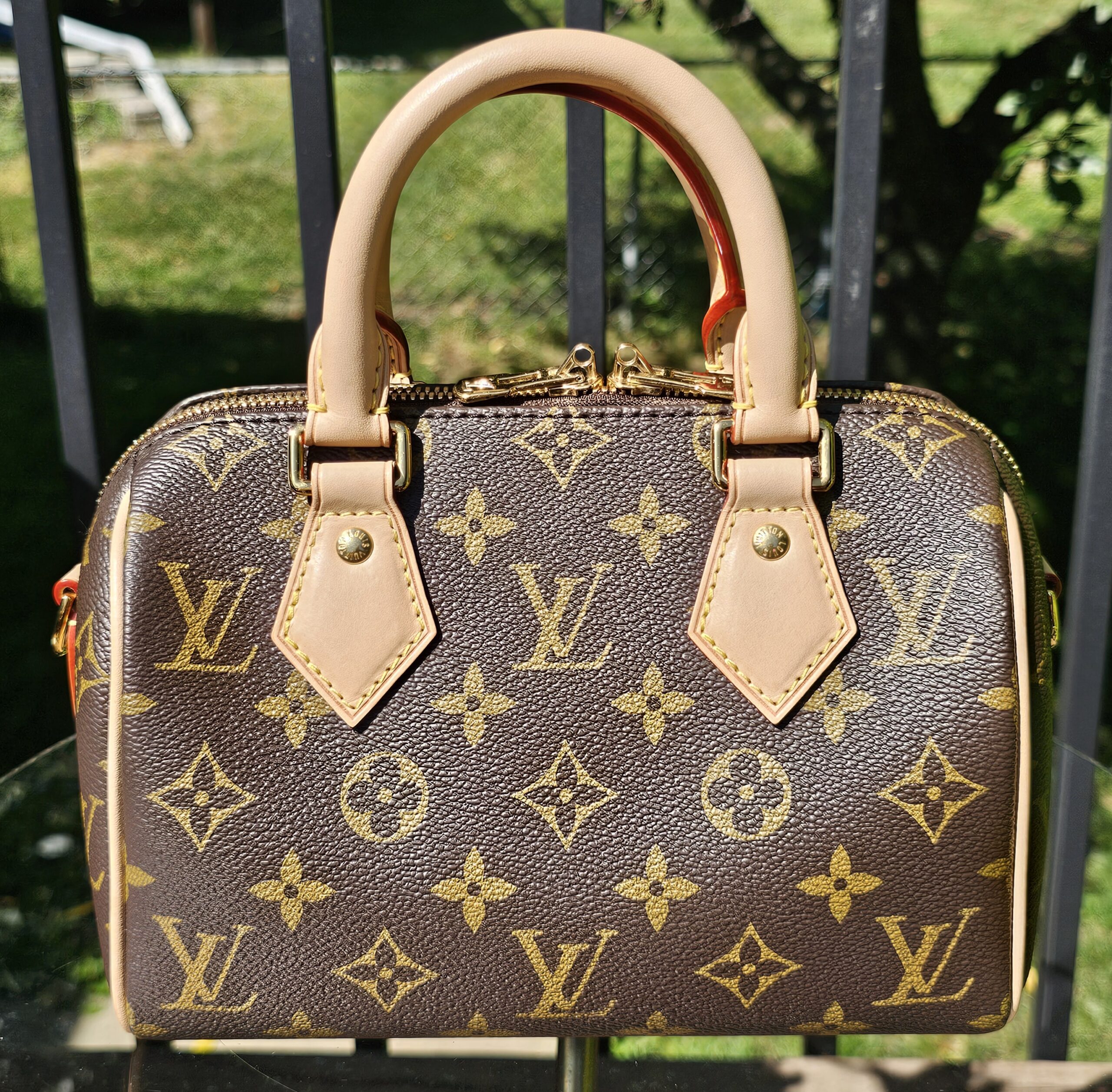 Front of the Monogram Speedy Bandouliere 20 with vachetta handles