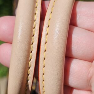 Rolled vachetta handles held together, showing light patina