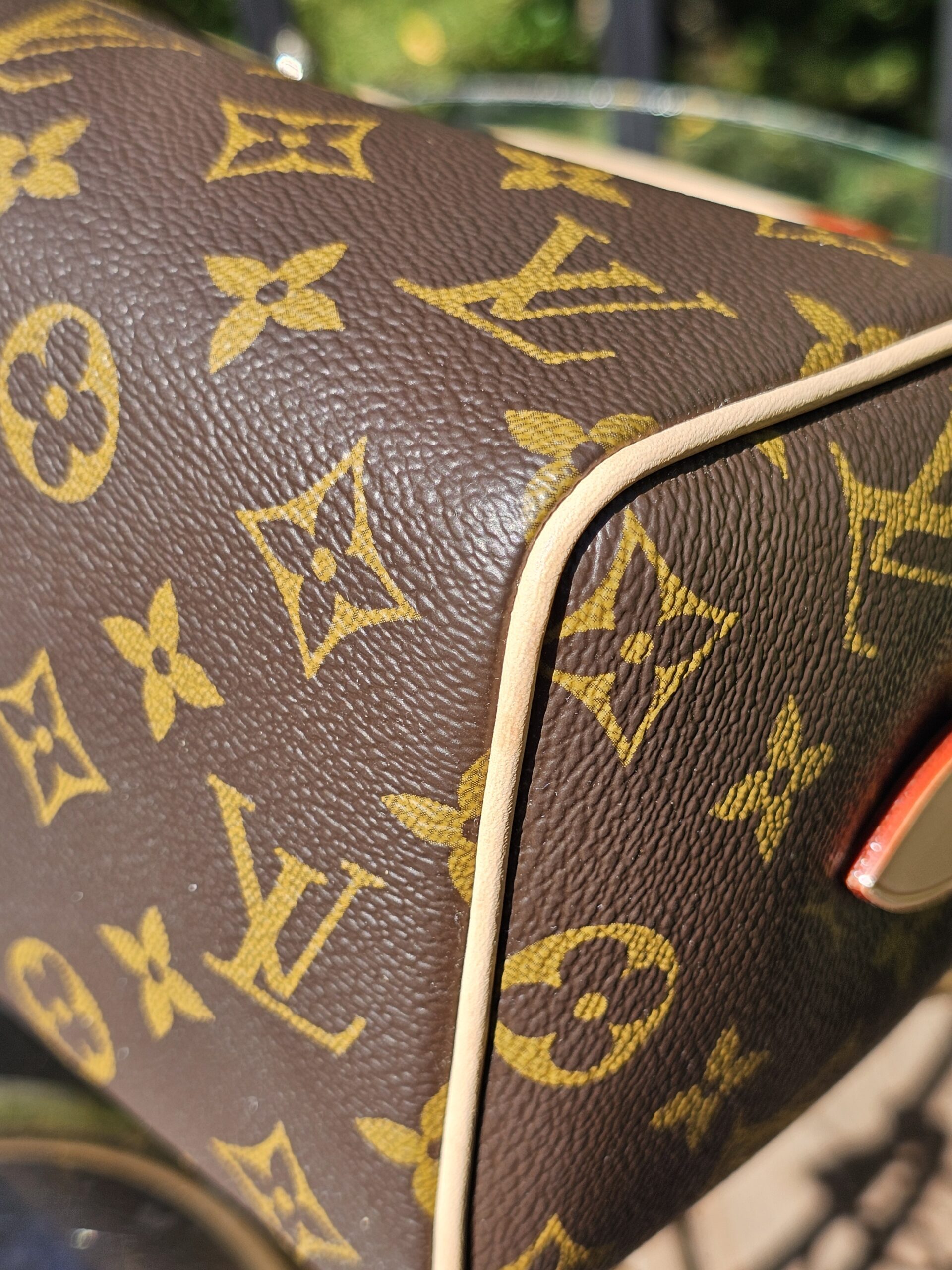 Corner of the Monogram canvas with red trim