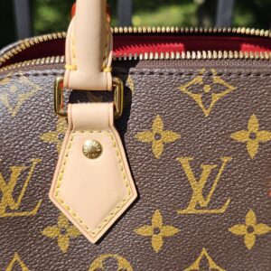 Handle attachment tab and gold-tone stud