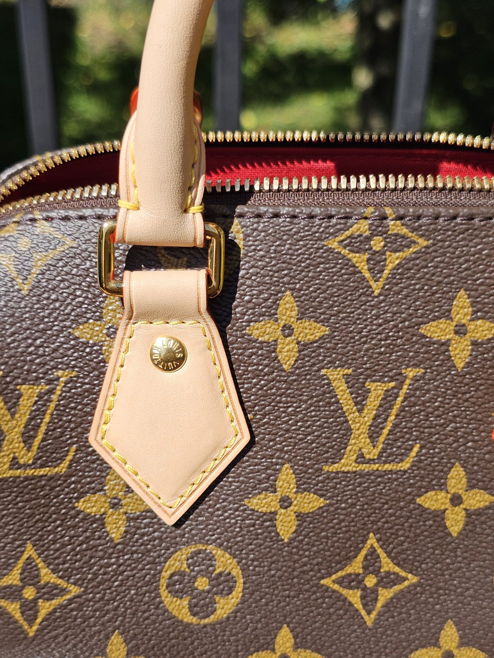 Handle attachment tab and gold-tone stud