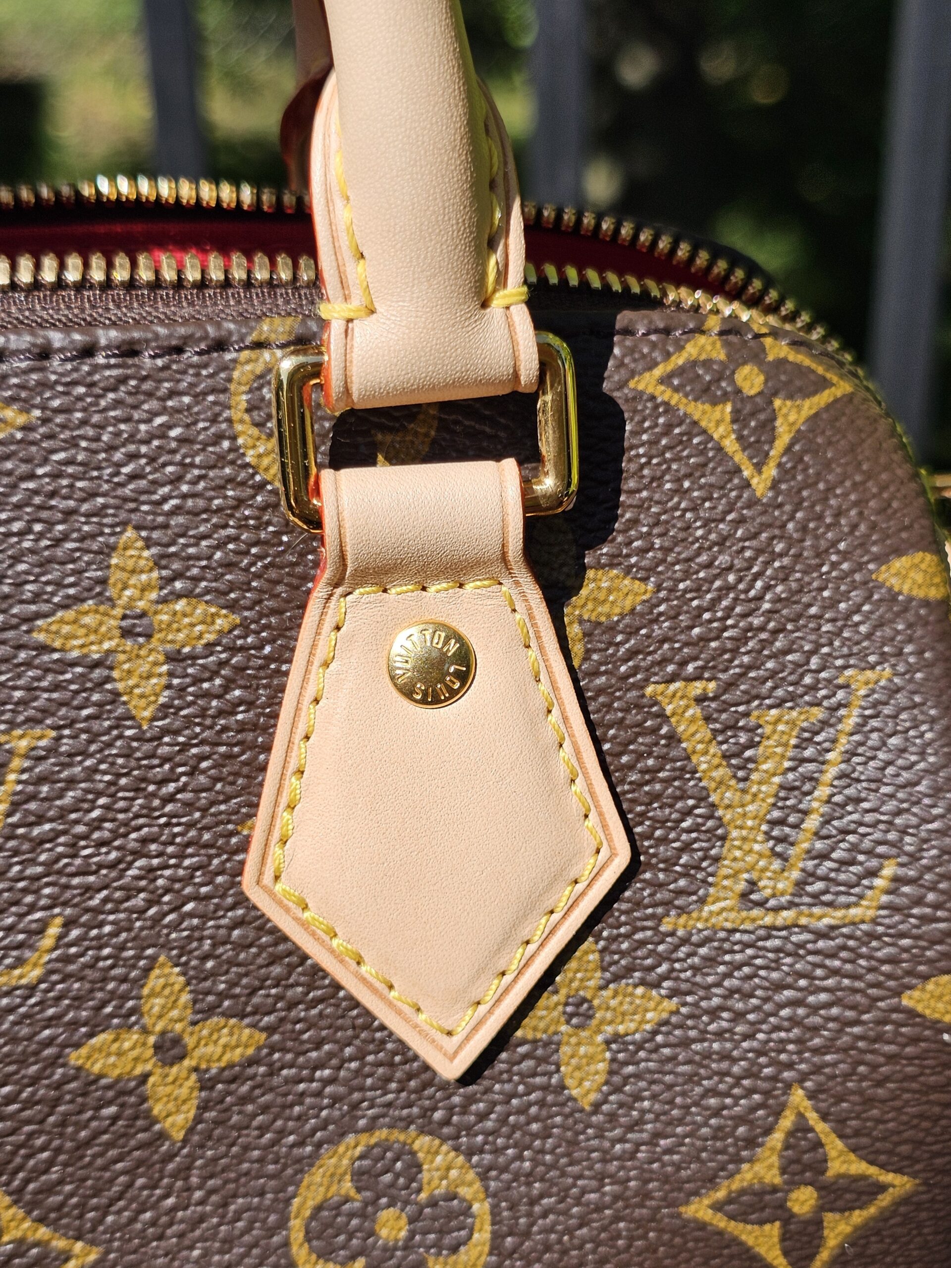 Handle tab beside the zip on the Monogram Speedy