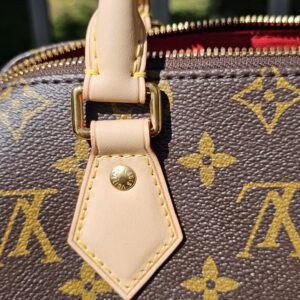Handle attachment showing light marks on the vachetta