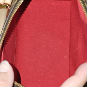 Speedy Bandouliere 20 held open to show the red interior