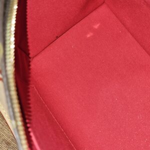 Red interior lining of the Monogram Speedy Bandouliere 20
