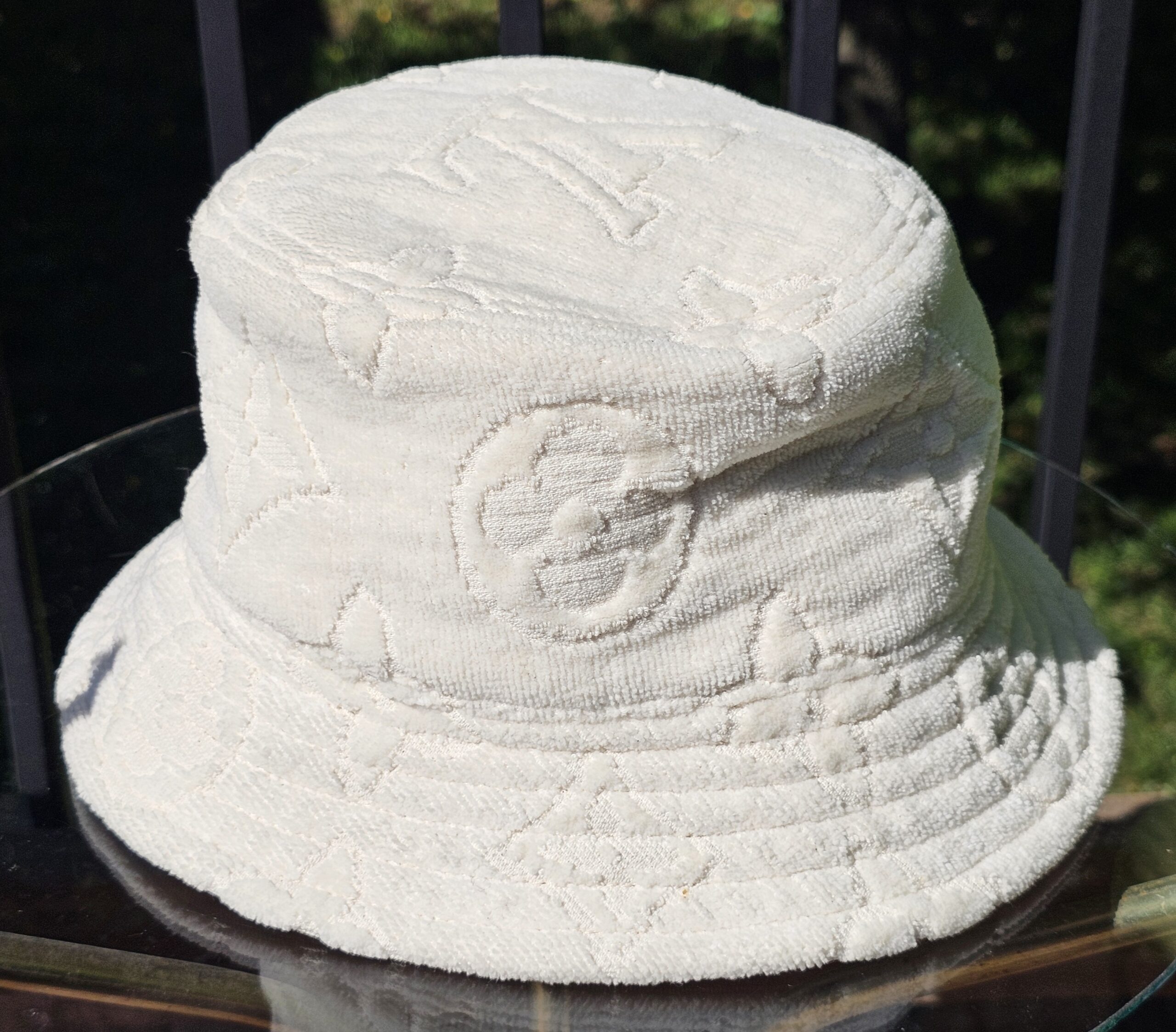 Side view of the cream Monogram jacquard bucket hat
