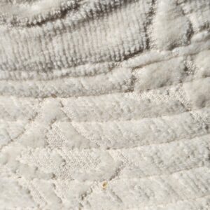 Close-up of the plush Monogram jacquard with a small mark