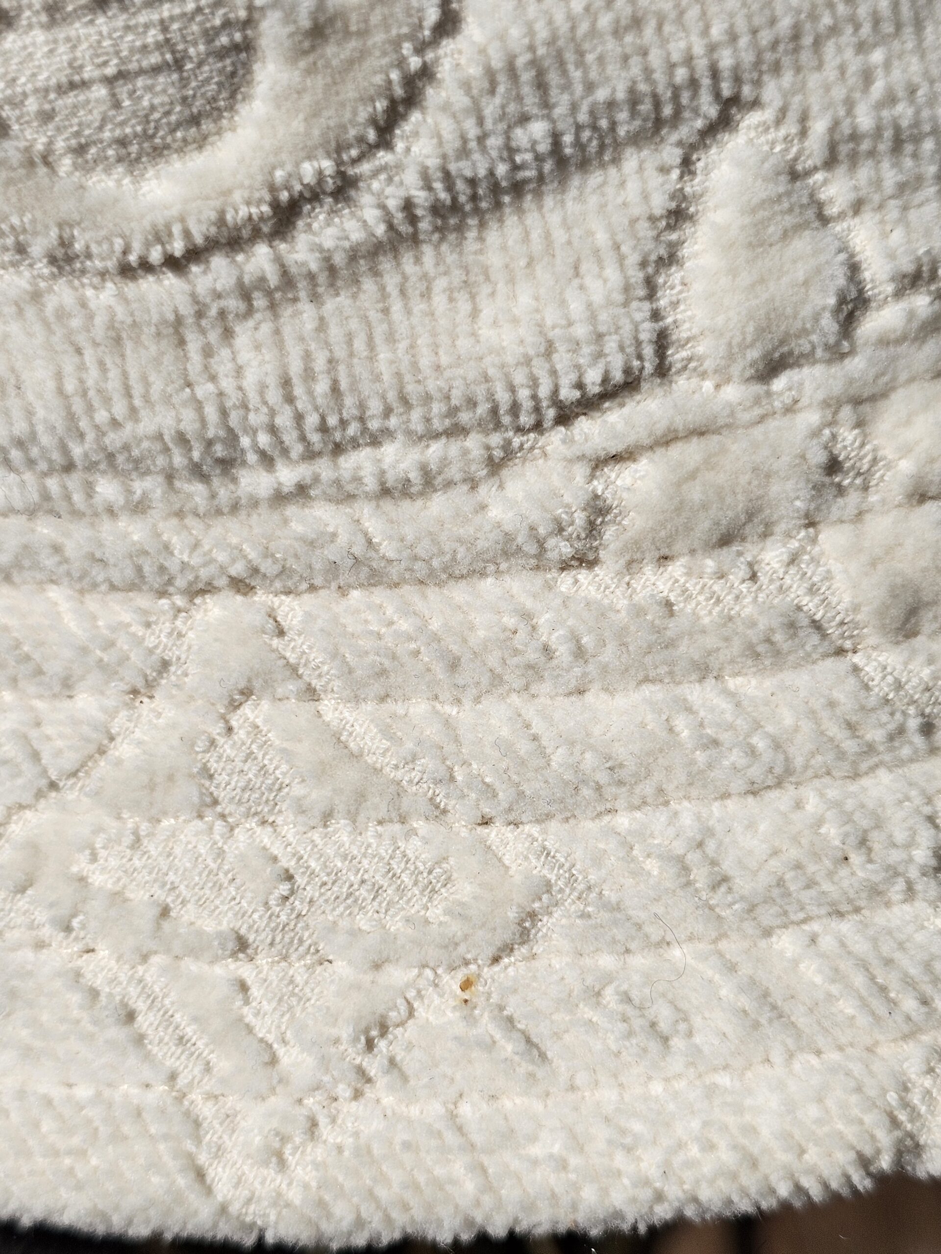 Close-up of the plush Monogram jacquard with a small mark