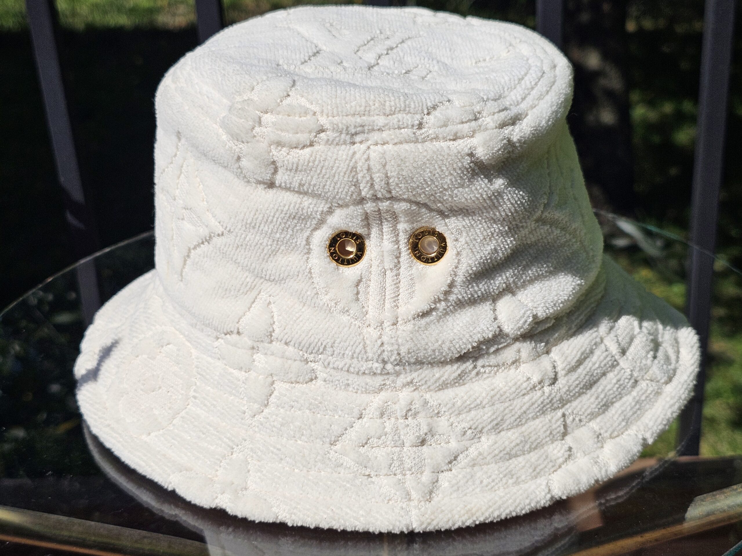 Gold-tone eyelets on the side of the LVacation bucket hat