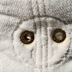 Close-up of the engraved gold-tone eyelets
