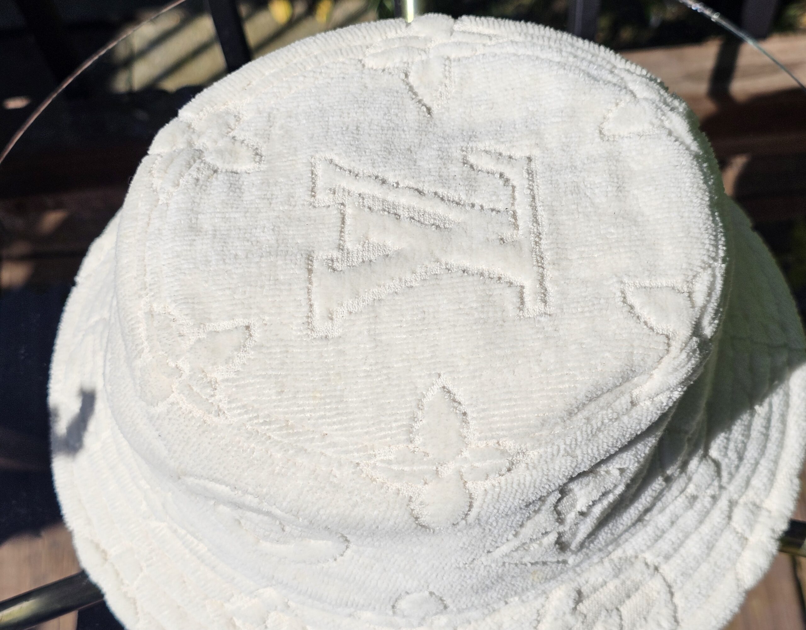 Top of the bucket hat showing the raised LV monogram