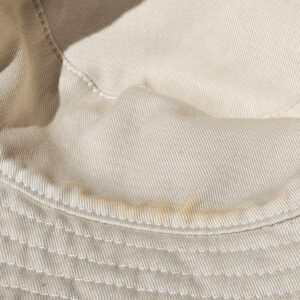 Smooth cream cotton reverse with light discoloration near the brim