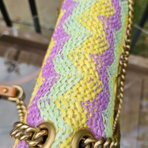 Top of the GG Marmont raffia bag with the chain strap coiled