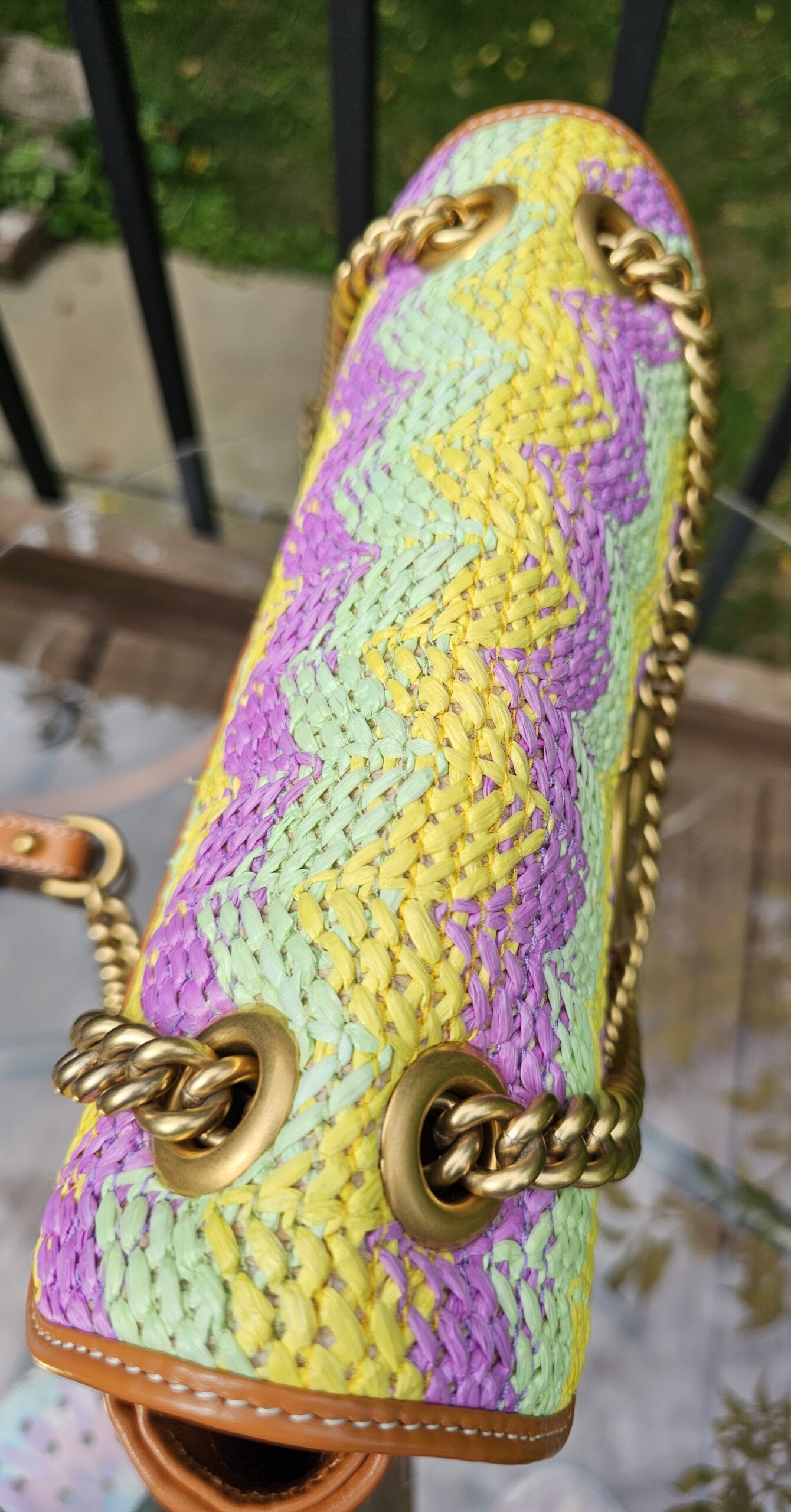 Top of the GG Marmont raffia bag with the chain strap coiled