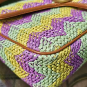 Corner of the raffia Marmont showing the tan leather piping