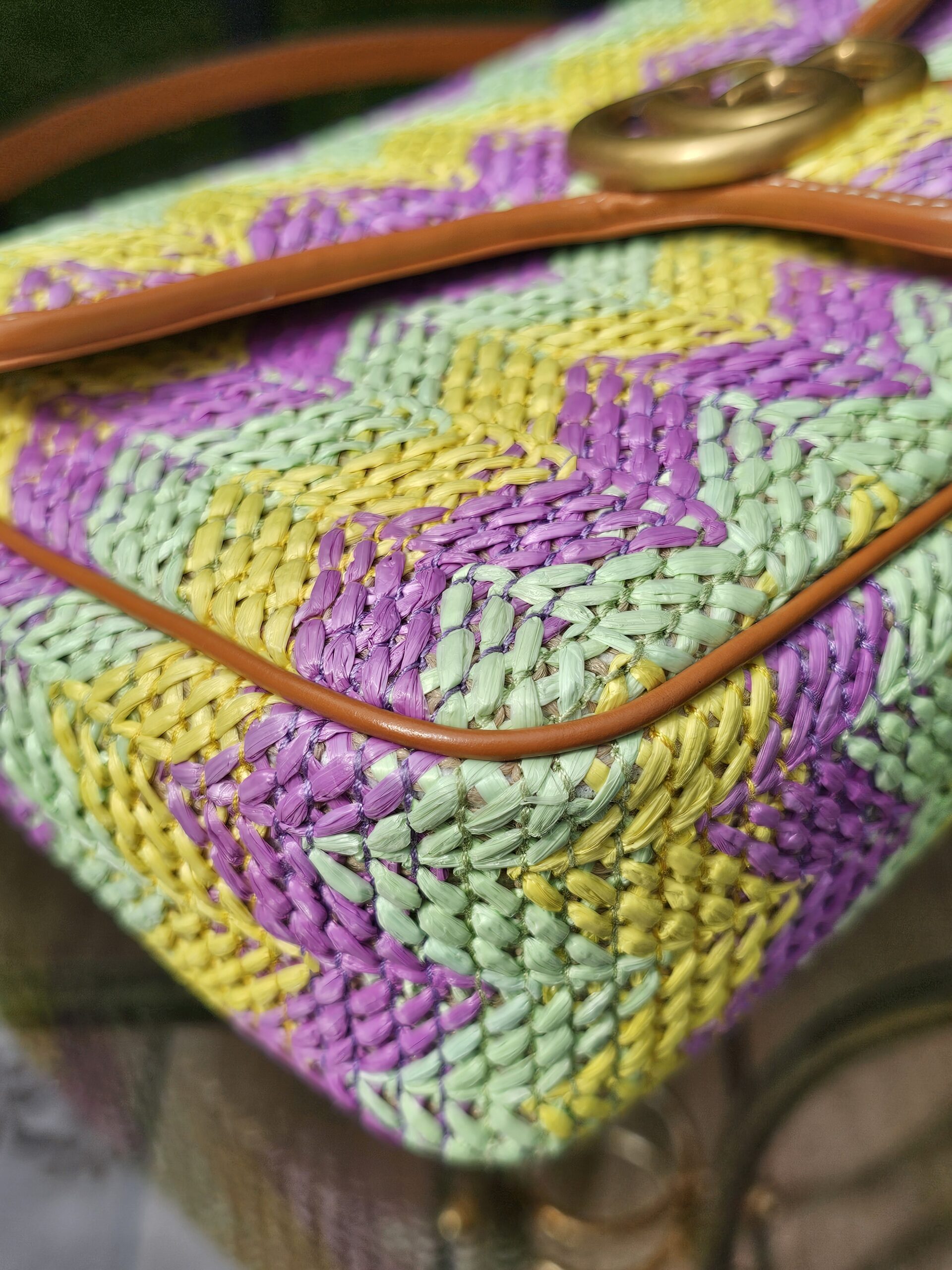 Corner of the raffia Marmont showing the tan leather piping