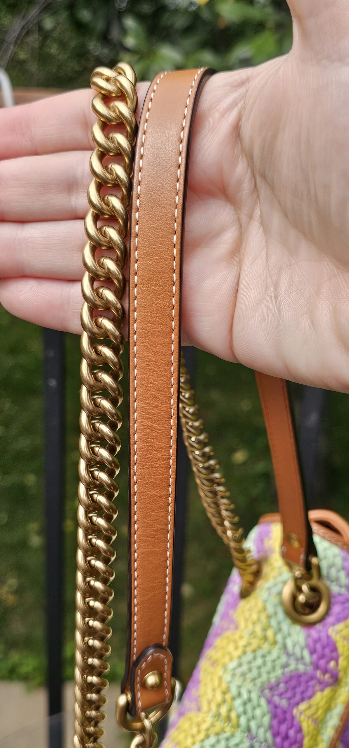 Sliding chain and leather strap held in hand