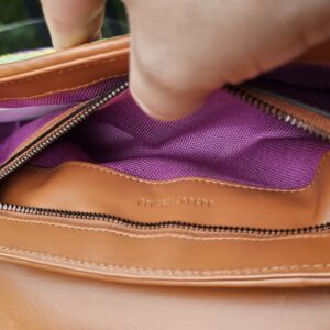 Interior zip pocket in the purple lining