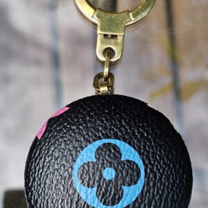 Reverse of the Astropill light key holder showing the blue Monogram flower