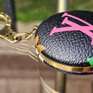 Astropill light key holder hanging from its gold-tone ring