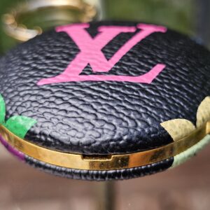 Close-up of the pink LV initials and Multicolor motifs on black coated canvas