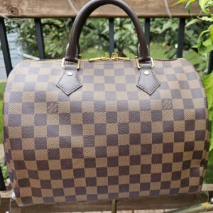 Front of the Damier Ebene Speedy Bandouliere 30 with rolled leather handles
