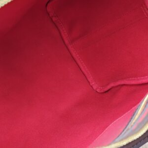Interior slip pocket in the red lining