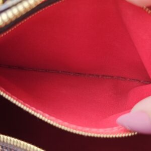 Red interior of the Damier Ebene Speedy with the zip track