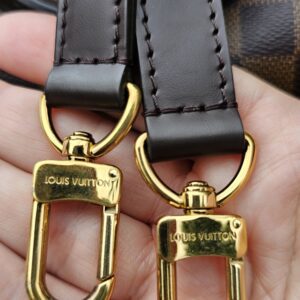 LOUIS VUITTON engraved snap hooks on the shoulder strap