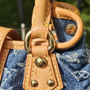 Gold-tone ring and vachetta tab showing patina