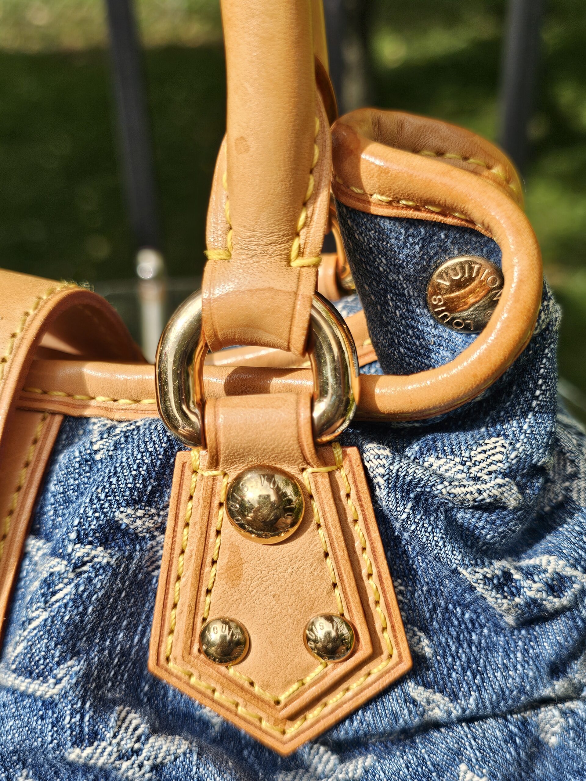 Gold-tone ring and vachetta tab showing patina
